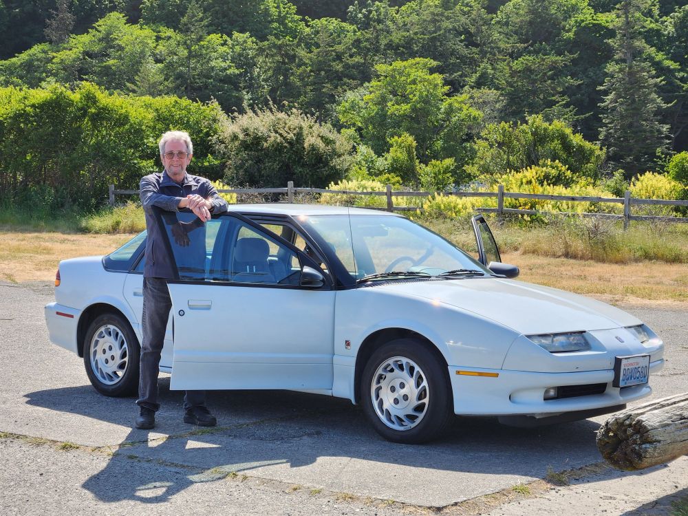 My dad standing next to my 1994 Saturn 2 years ago