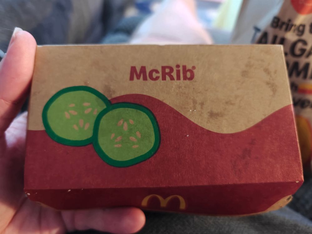My hand holding a McRib box
