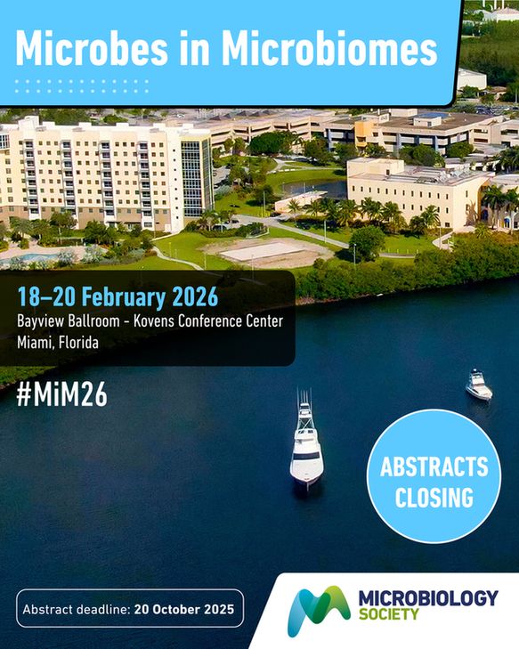 Visual description: image shows view of the Bayview Ballroom - Kovens Conference Center Miami, Florida, where Microbes in Microbiomes will be taking place 18 - 20 February 2026. Bottom-right features a blue circle that reads 'Register now' and the Microbiology Society logo. 
