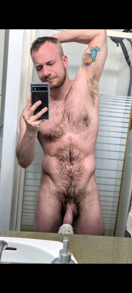 Mirror selfie, post shower, showing bush and shaft. Flexing abs, arm behind head. 