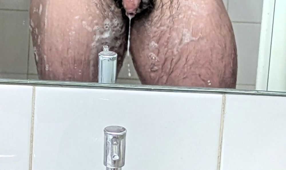 Photo showing tip and soapy precum dripping from tip of penis. 