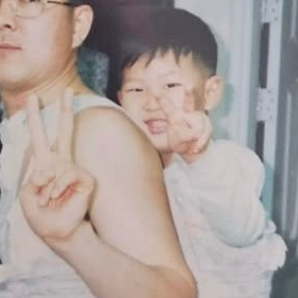 A picture of 2 or 3 year old Namjoon (RM of BTS) being piggybacked by his father.