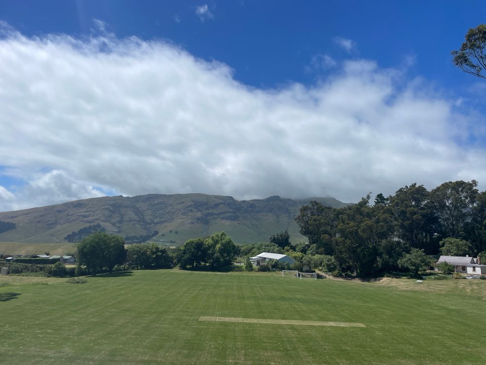 A playing field out the back of Diamond Harbour. Mist on the peak behind.