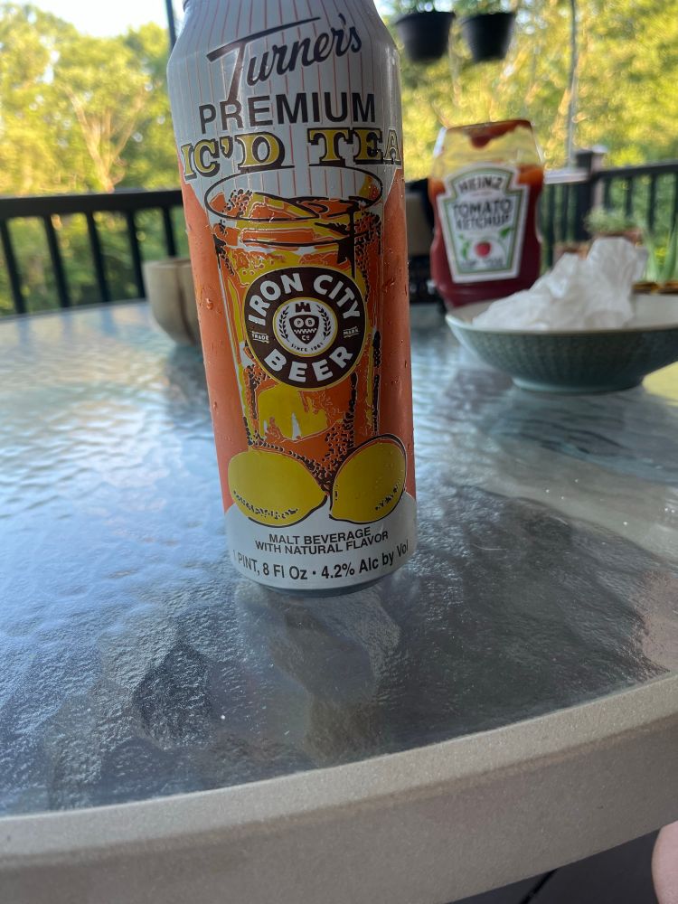 a can of Turner’s Premium IC’D Tea, a beer from Iron City Beer, with a bottle of Heinz ketchup in the background