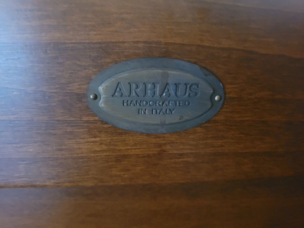 A nameplate that says Arhaus handcrafted in italy