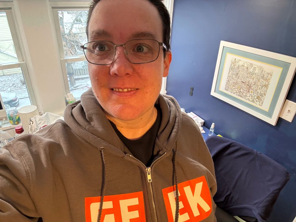 Me, wearing a grey hoodie with GEEK in large letters on the front in BGG font. 
