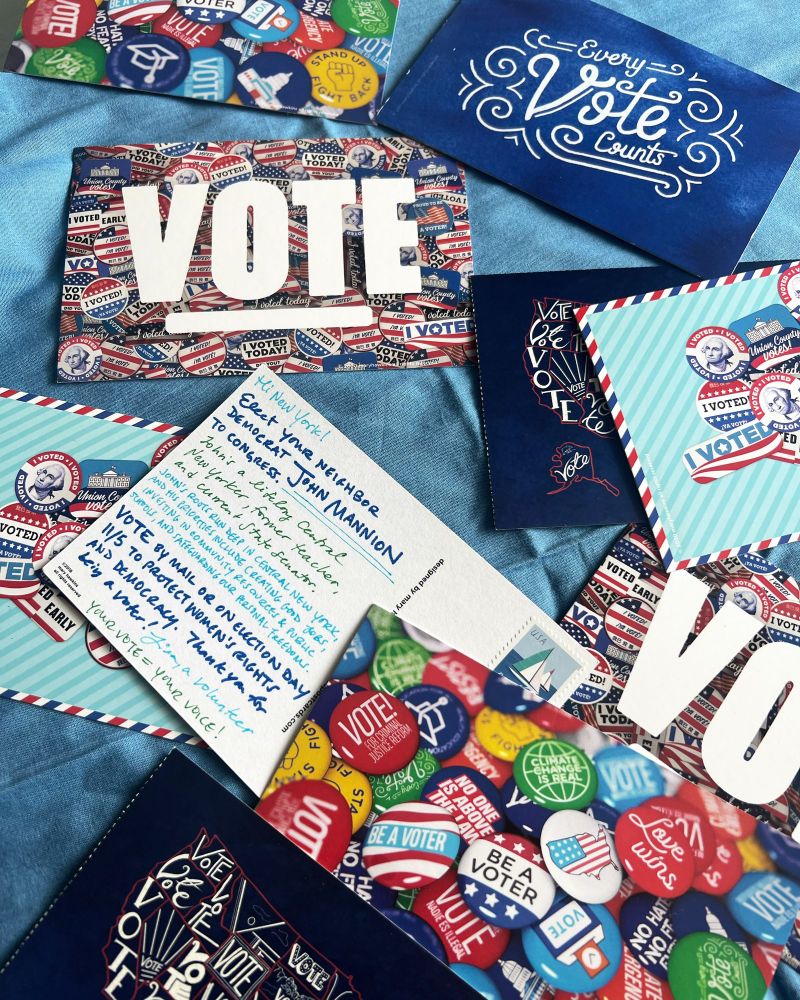 A pile of handwritten postcards to voters