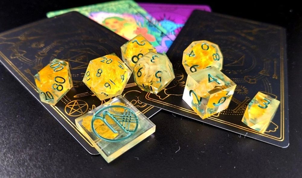 a transparent dice set with yellow buttercups and green numbers