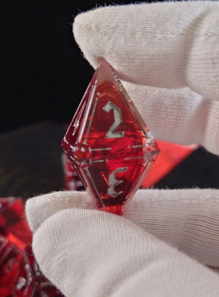 a red eight-sided dice with splotches that looks like blood