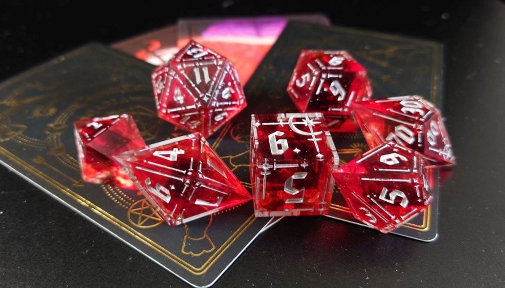 a set of red dice with splotches that looks like blood