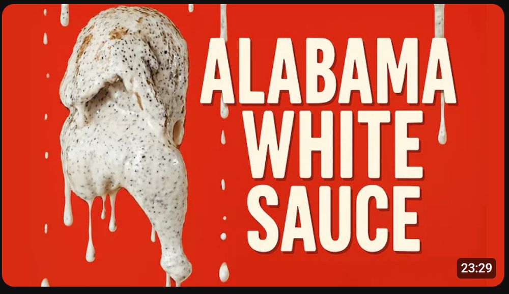 An image of two chicken legs being coated in a peppery white sauce next to the caption "alabama white sauce"