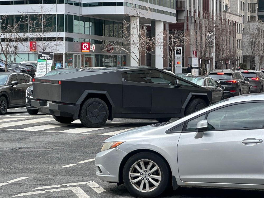 Photo of Tesla Cybertruck. It was black and is all angles.