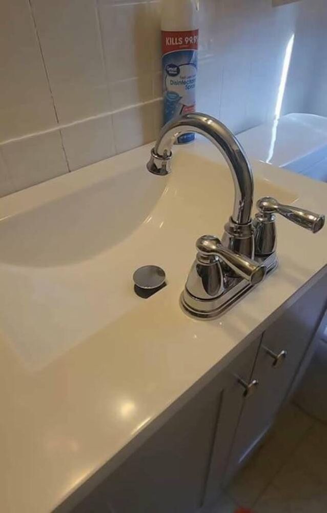 A washbasin with the tap installed on the side facing you