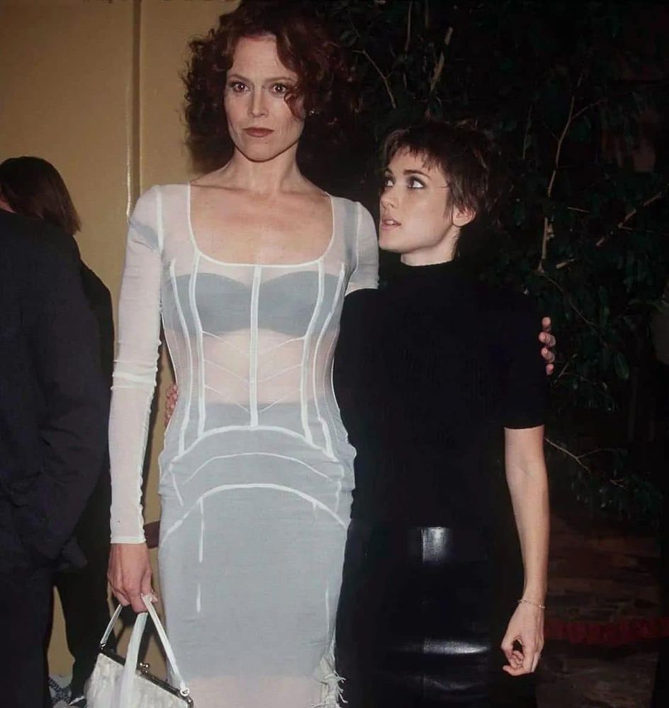photoshoot of shorter winona ryder gazing lesbianly up at taller sigourney weaver