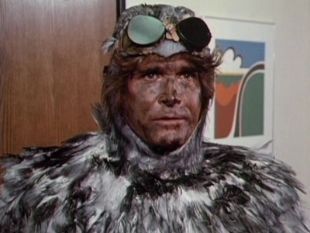 Michael Landon dressed in a bird costume with a dirty face.