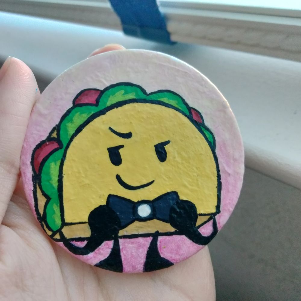 Taco ii painted on a button