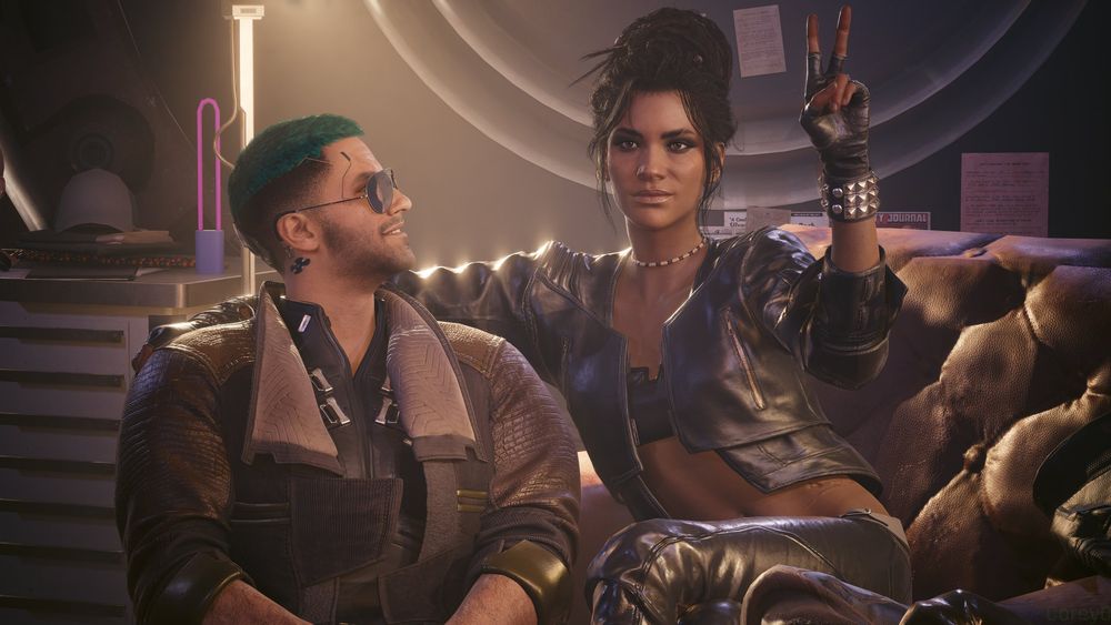 Panam has her arm around Corey V's shoulder and is making a two-fingered "V" gesture to someone off-camera while Corey V smiles up at her.