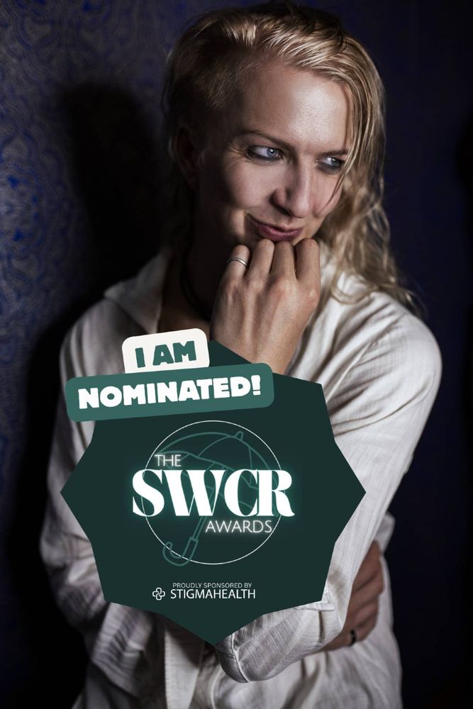 Kai silver posing in a white shirt with a tag for being nominated for the SWCR awards. 
