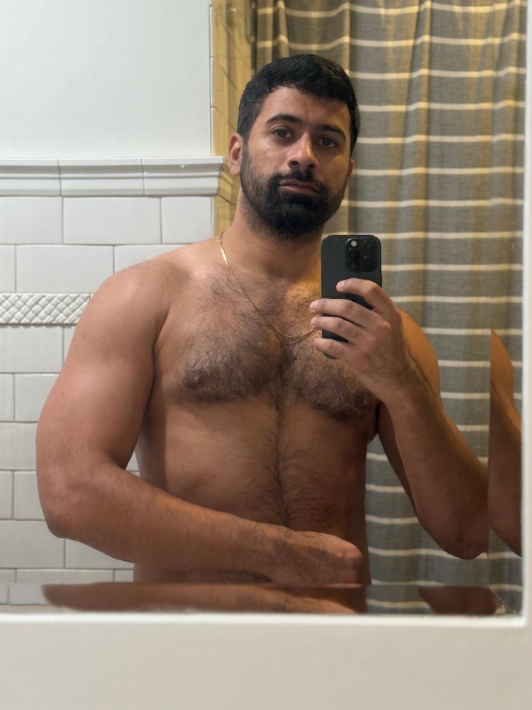 shirtless mirror pic in my bathroom flexing my left arm