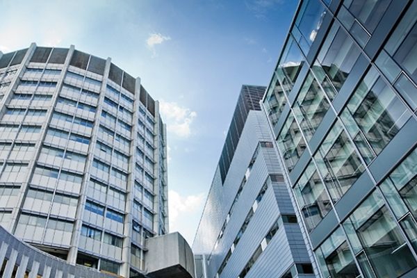 Exterior view of McGill’s Life Sciences Complex, featuring modern glass architecture under a blue sky.