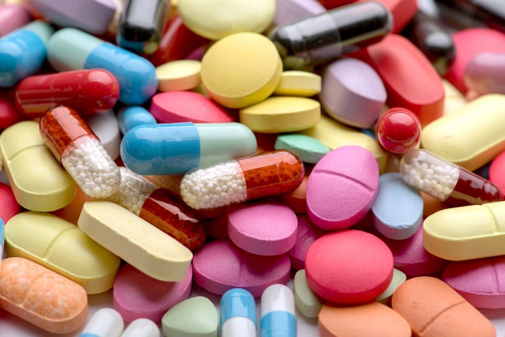 Close-up of assorted colorful pills and capsules in various shapes and colors.
