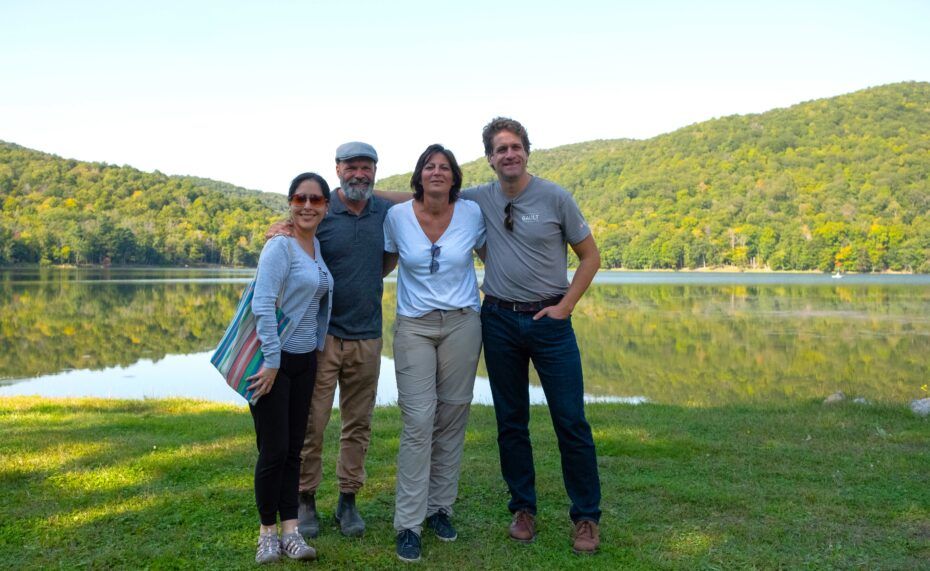 People standing in front of body of water at the gault nature reserve - Johana Reyes (Founding Member and President of the Board, Alliance for a Sustainable Amazon), Martin Duval (Services and Security Manager, Gault Nature Reserve), Natalie Beenaerts (Professor at UHasselt and project leader of the Field Research Centre), and David Maneli (Associate Director, Gault Nature Reserve).