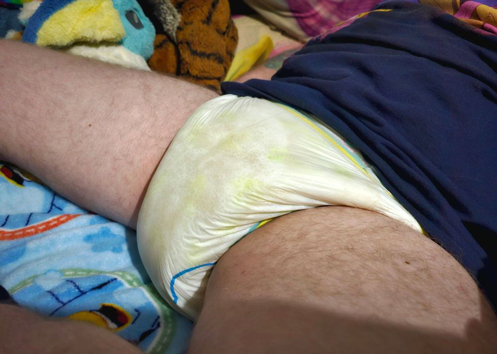 Me lying on a Bluey blanket in a soggy Unicorns adult nappy... from a very slightly different angle. 