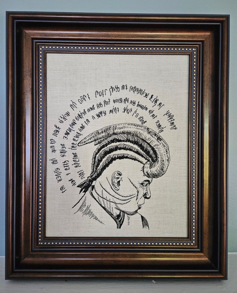 An embroidered portrait of Wyll Ravengard from Baldur’s Gate 3. His head is ringed by Infernal script like a halo. He’s looking down and to the right, an expression of grief on his face and three tears trickling down his cheek.