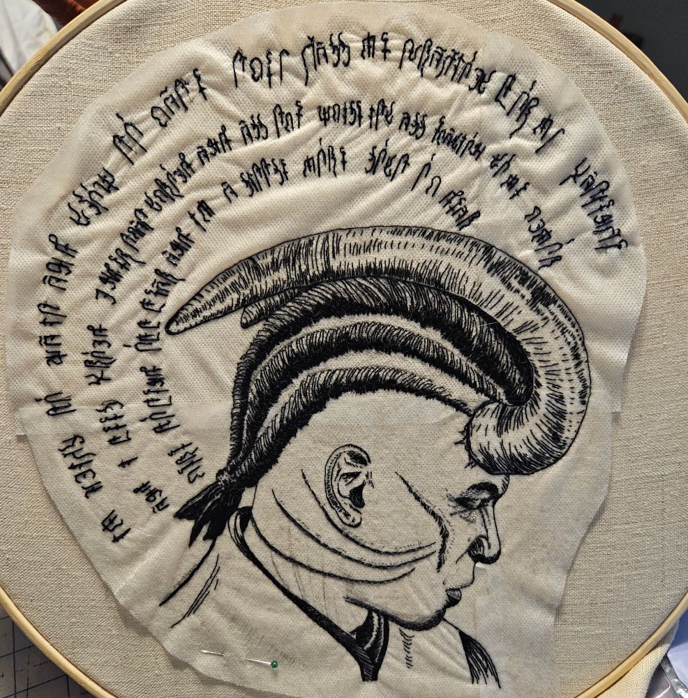 Nearly-finished embroidery of Wyll Ravengard from Baldur’s Gate. Only a few details around his shirt and neck scars remain to be finished.