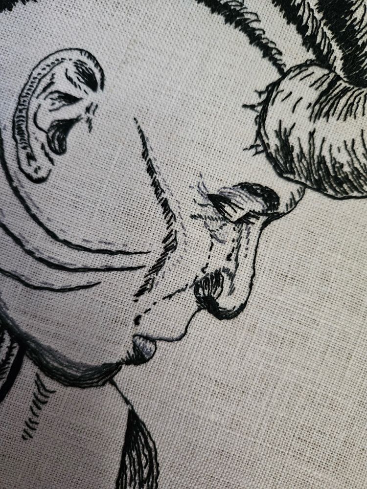 Close-up of the detail around the face of the Wyll Ravengard embroidery portrait