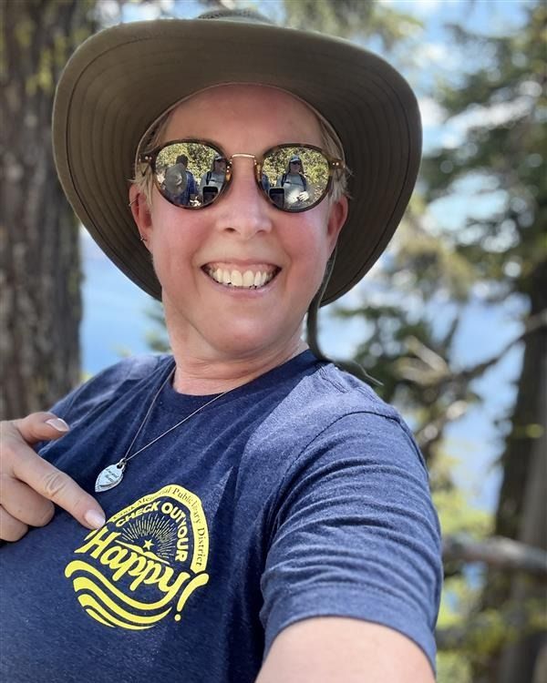 Library staff member showing off her Check Out Your Happy t-shirt while on vacation.