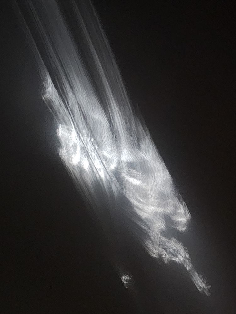 Abstract image of white light streaks on a dark background.