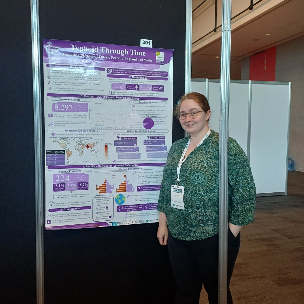 Alice Nisbet stood beside her scientific poster describing her work on examining typhoidal Salmonella.