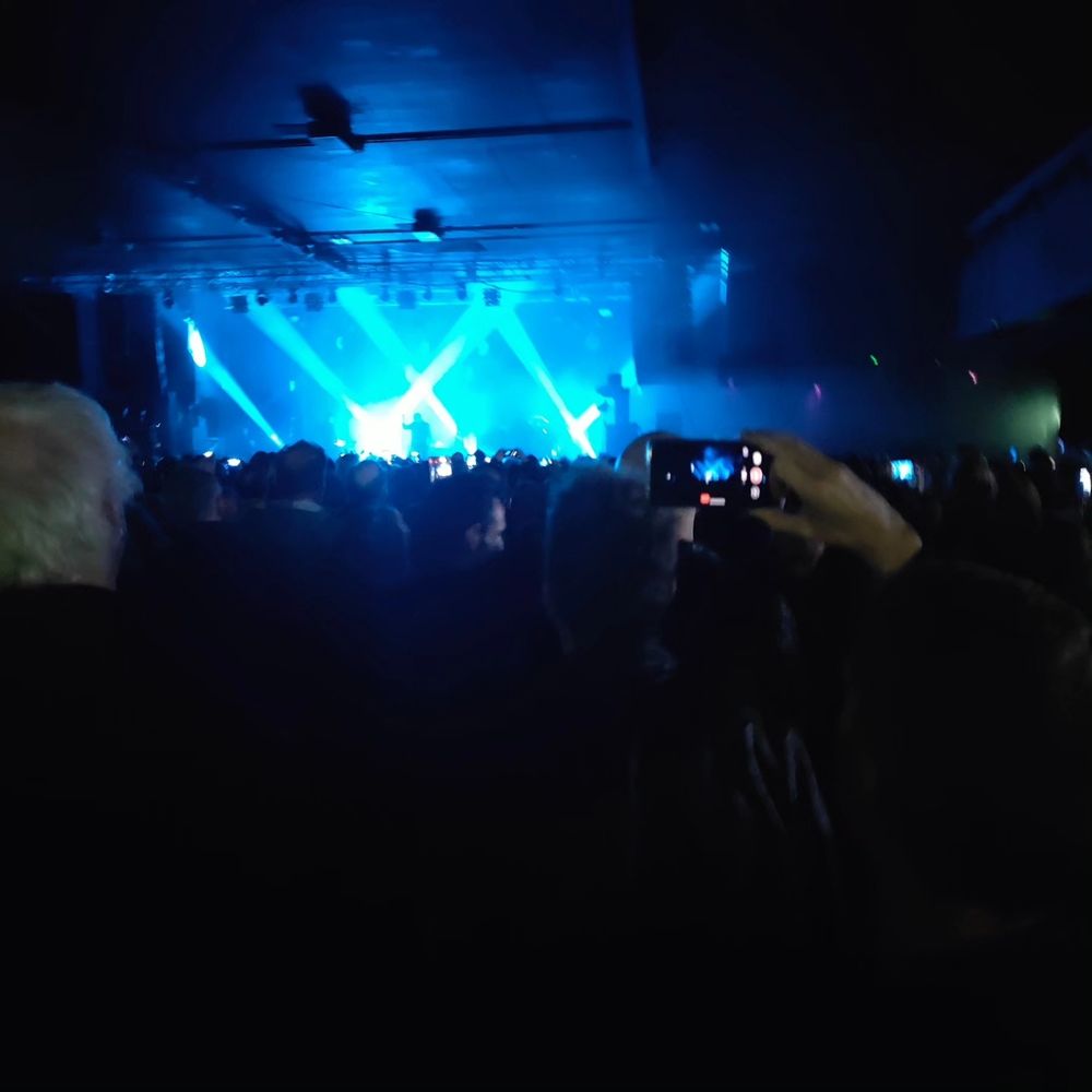 The Sisters of Mercy on stage, performing their opener, Black Planet.