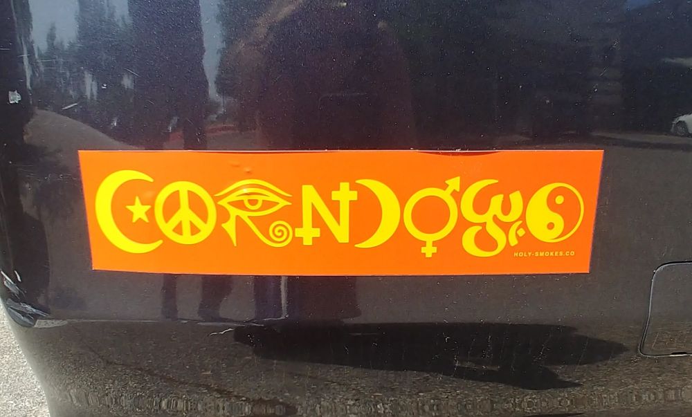 Bumper sticker that says CORNDOGS in a font made up of religious symbols