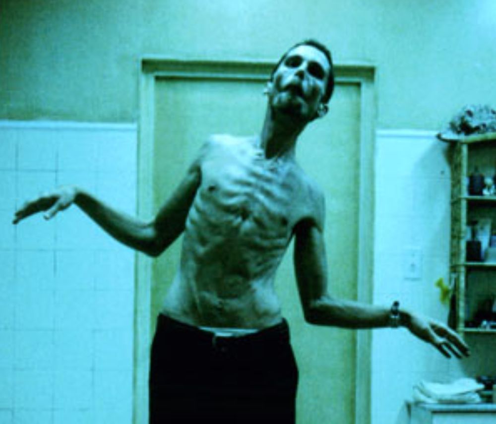 Screenshot of Christian Bale in "The Machinist," in which he is shirtless, with every rib visible. This man dropped to less than 100 pounds to play this role.