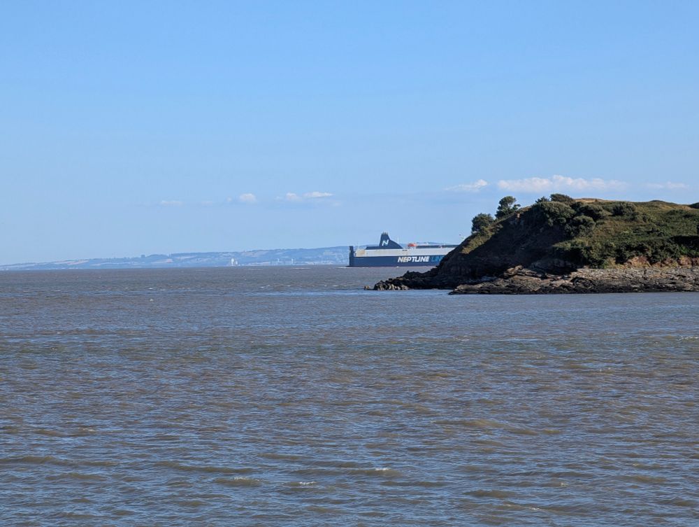 An island with a large ship poking out the side