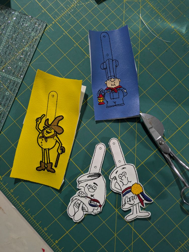 Machine embroidered key fobs of characters from school house rock.