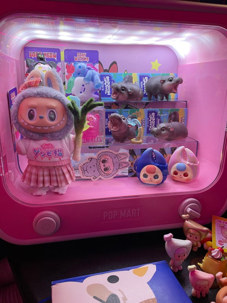 Sea Salt Coconut Labubu in my Pop Mart Power Puff Girl Cry Baby desk display case holding on to her needle felted leek for dear life.