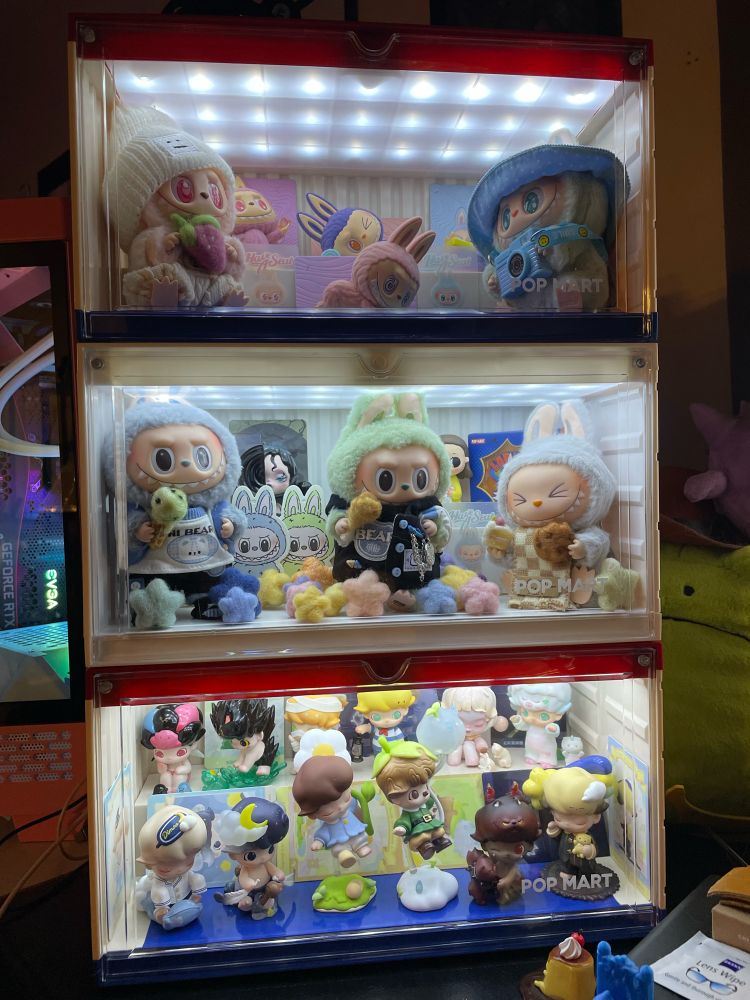 3 Pop Mart luminous display cases filled with Labubu, Dimoo, and Skullpanda products.