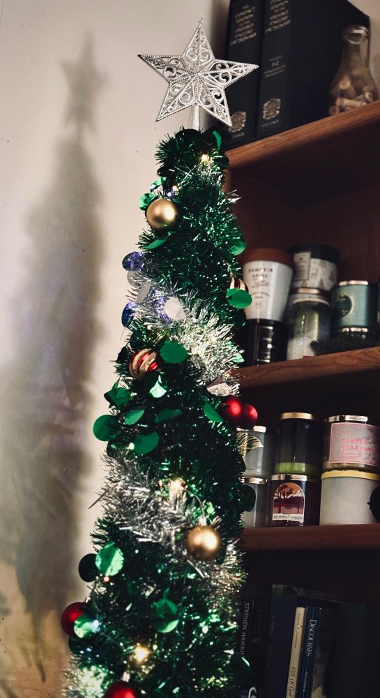 Tinsel christmas tree with silver star.  