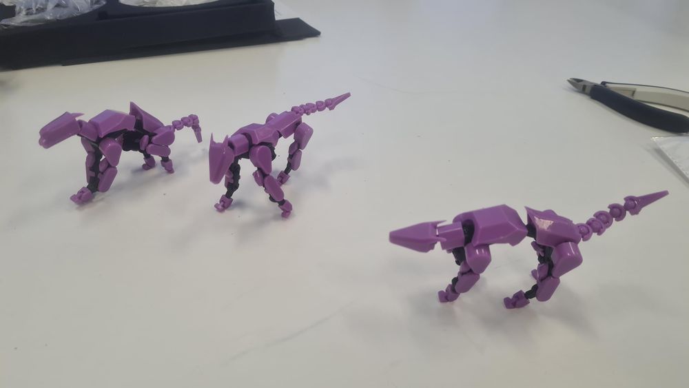 Three model kits, purple and black dogs