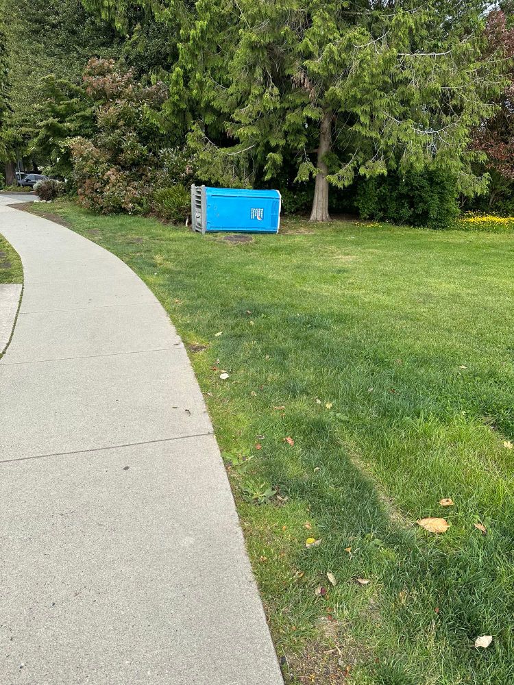 Temporary toilet in Hastings Mill park dumped on its side by vandals.