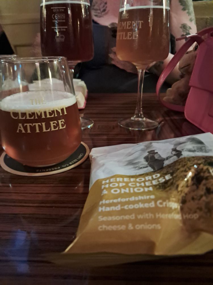 Half of beer, bag of crisps