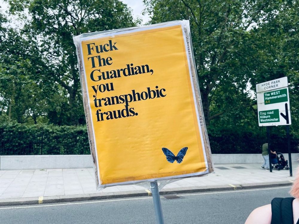 Sign saying "Fuck The Guardian you transphobic frauds"