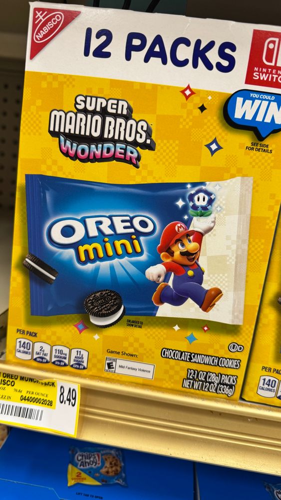 Display packaging of Oreo Mini cookies with Super Mario Bros. Wonder theming - a jumping Mario is shown on the packaging.