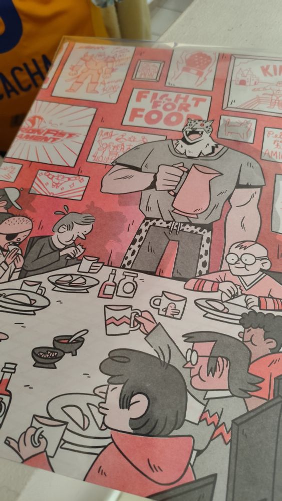 Picture of a poster that shows the character King from the Tekken series standing at the end of a long table with a big smile and a water pitcher while the kids from the orphanage enjoy some good tacos with salsa.