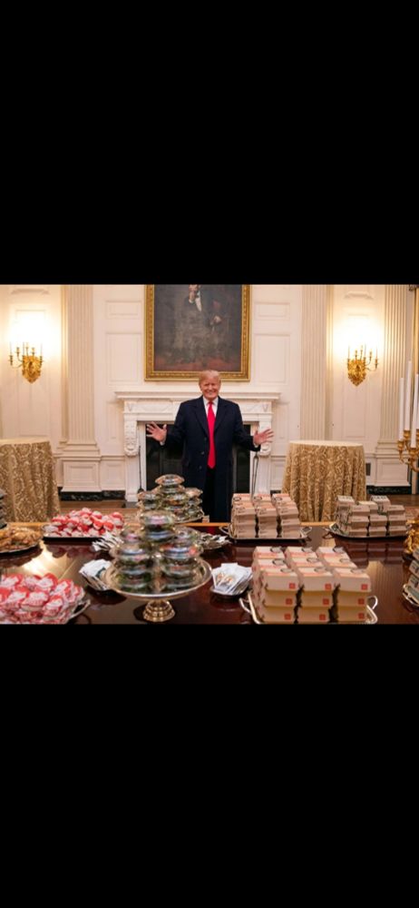 Trump standing with a McDonald's buffet 