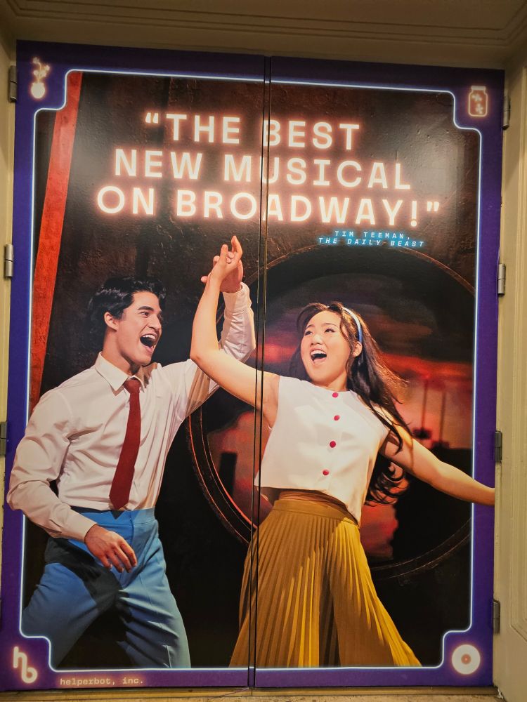 Poster outside the Belasco Theatre with the quote "The Best New Musical on Broadway" and an image of the 2 stars of Maybe Happy Ending