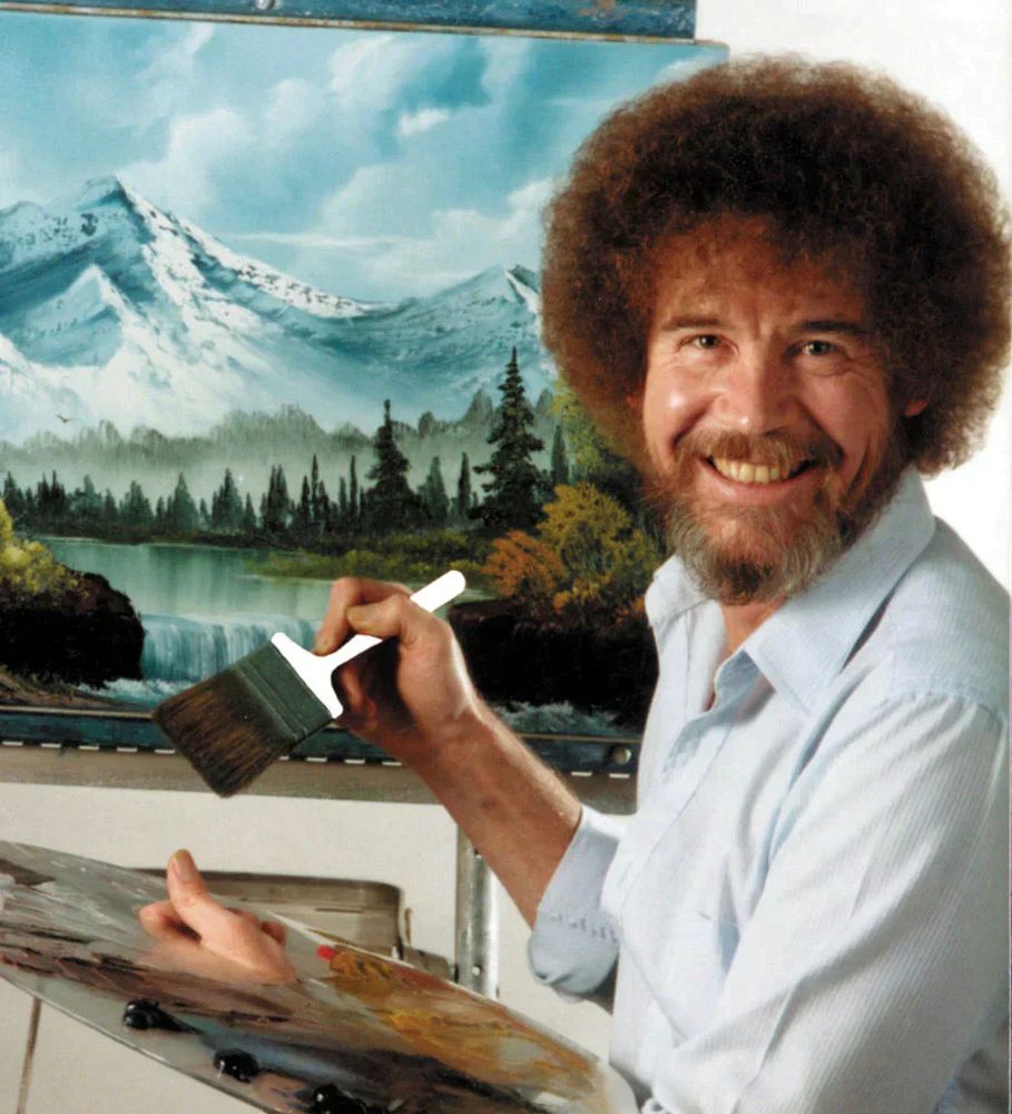 Bob Ross with a painting he made